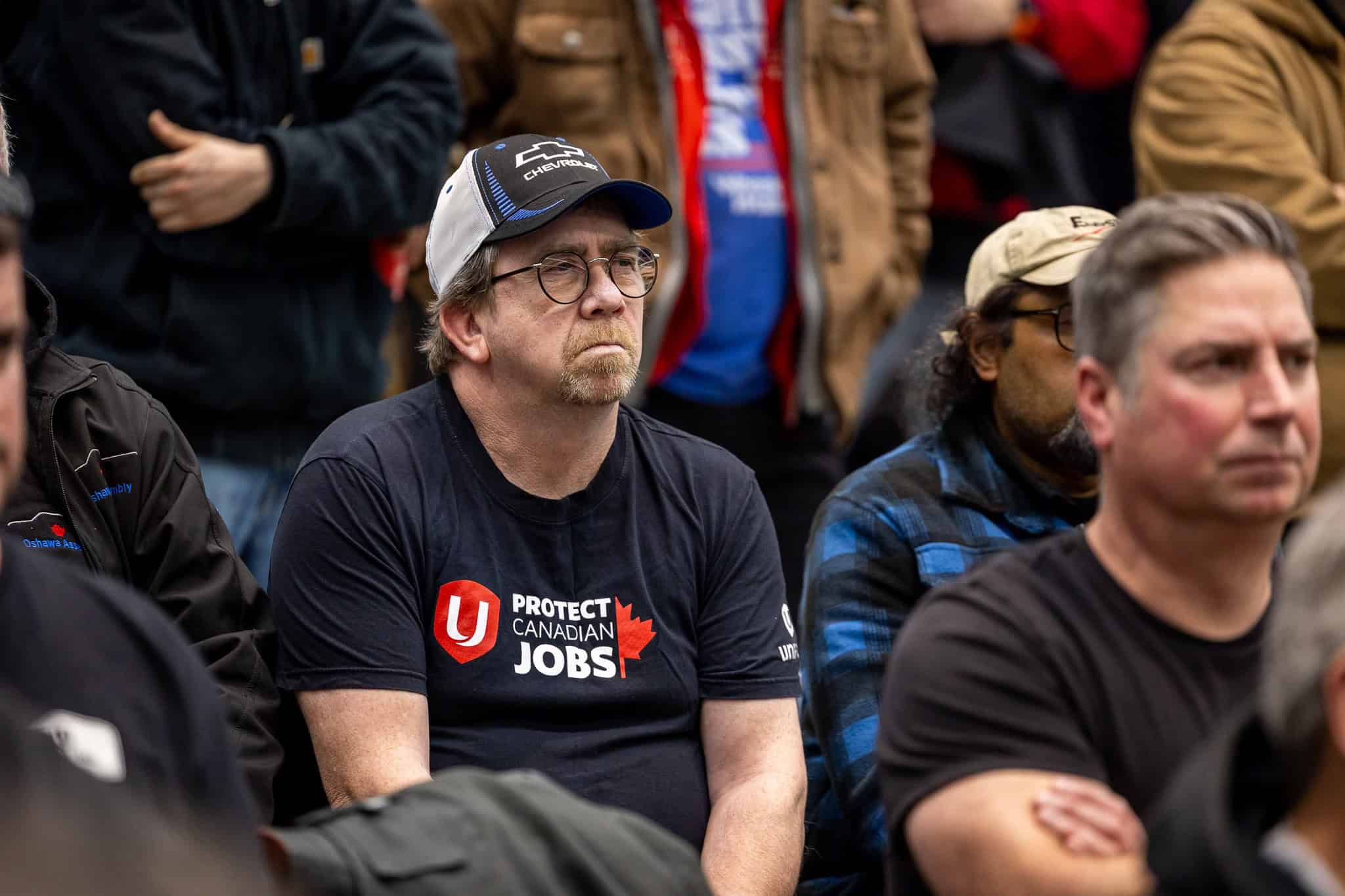 An anxious crowd of Oshawa auto workers at a union meeting Saturday